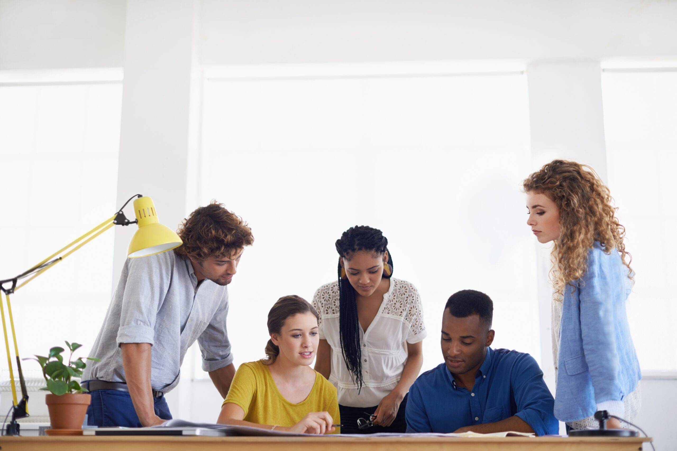 A team working together at their computer.